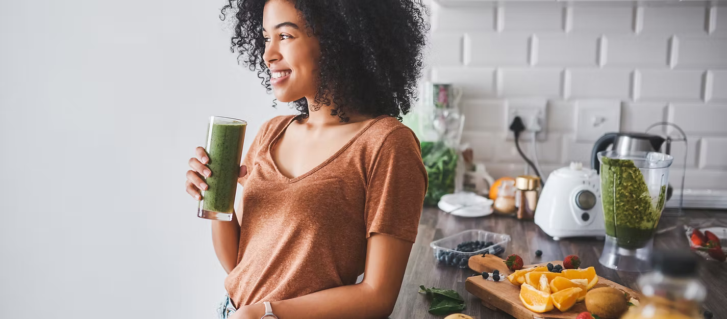 Woman enjoying a green smoothie